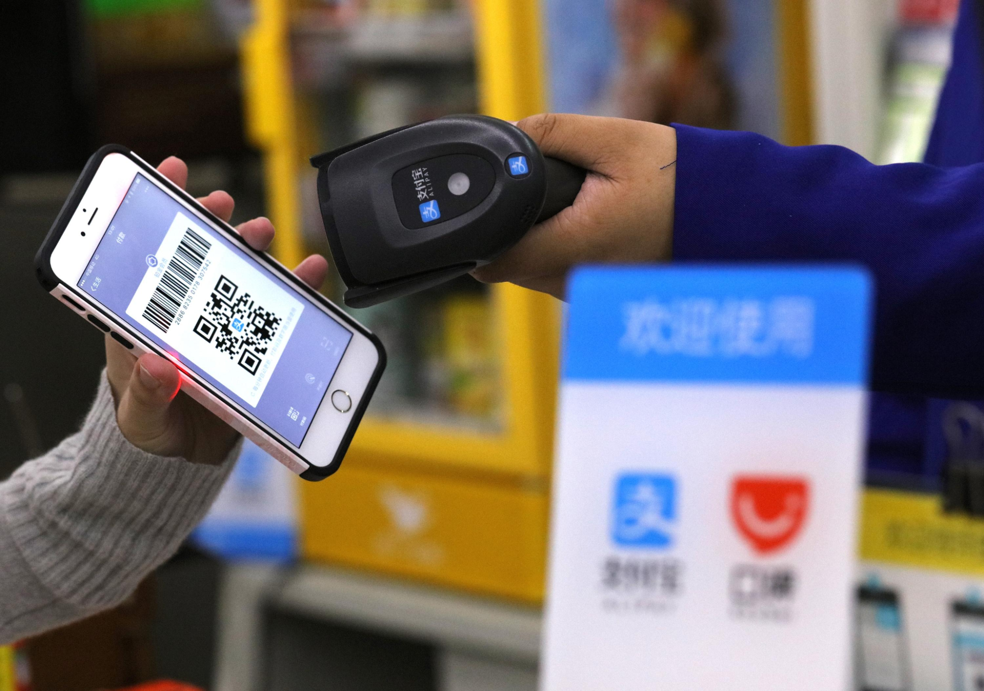 Shopper paying with an AliPay QR code